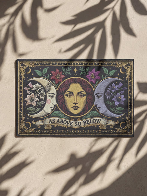 A triple moon doormat featuring the sacred symbol of maiden, mother, and crone, rendered in antique gold on a black ground with botanical detailing—designed for witchy homes, Wiccan spaces, and those drawn to divine feminine symbolism