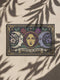 A triple moon doormat featuring the sacred symbol of maiden, mother, and crone, rendered in antique gold on a black ground with botanical detailing—designed for witchy homes, Wiccan spaces, and those drawn to divine feminine symbolism