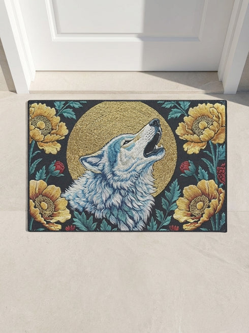 Grimoire and Goblet rectangular doormat featuring a faux embroidery style printed design of a howling wolf with blue and ivory fur, centered in front of a textured antique gold circular moon disc, surrounded by large golden yellow flowers, teal leaves, and small red berry accents on a dark charcoal background. Entryway rug with black trim, non slip backing, and botanical nature inspired mystical design.