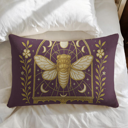 A rectangular lumbar pillow cover in a deep, moody plum-purple. The pillow features a detailed, symmetrical design in a shimmering gold color. In the center is a large, ornate cicada with translucent, veined wings, facing forward. The cicada is framed by a gothic-style archway with intricate patterns. Above the arch is a full moon, flanked by waxing and waning crescent moon phases. The design is bordered by vertical botanical vines with small flowers and stars, completing the mystical aesthetic."