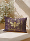 A rectangular lumbar pillow cover in a deep, moody plum-purple. The pillow features a detailed, symmetrical design in a shimmering gold color. In the center is a large, ornate cicada with translucent, veined wings, facing forward. The cicada is framed by a gothic-style archway with intricate patterns. Above the arch is a full moon, flanked by waxing and waning crescent moon phases. The design is bordered by vertical botanical vines with small flowers and stars, completing the mystical aesthetic.