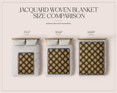 A woven cotton throw featuring a celestial sun face pattern in gold and black tones, framed by soft fringe.