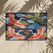 Grimoire and Goblet chinoiserie flying crane faux embroidery doormat featuring three cranes in coral blush and jade green soaring across deep navy background with teal scalloped clouds golden bonsai branches and olive foliage. Printed polyester entryway mat with non-slip rubber backing and black trim. Available 24x18 and 36x24 inches. Asian inspired Japanese crane design housewarming gift home decor