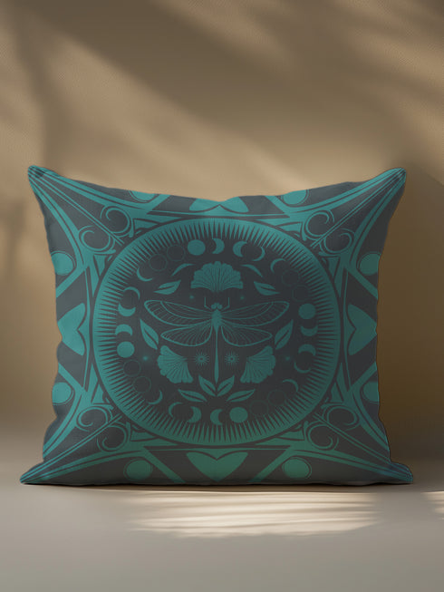 Square pillow cover featuring an intricate emerald green dragonfly design centered in a medallion surrounded by moon phases and Art Nouveau geometric patterns on a dark charcoal background.