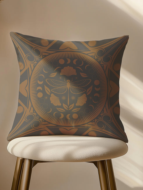 Square pillow cover featuring a detailed copper dragonfly illustration centered in a circular medallion with moon phases and Art Deco geometric patterns on a dark gray background.