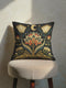 A square black luxury throw pillow from GrimoireandGoblet, complete with a plush insert and a soft, linen-feel polyester case. The pillow's case features an intricate, symmetrical Art Nouveau design. In the center is a large, stylized lotus flower in red, teal, and gold. The printed design mimics the rich texture of vintage tapestry or embroidery. This dark, moody, celestial, and floral Grimoire and Goblet pillow has a premium, seamless hidden zipper on its case.