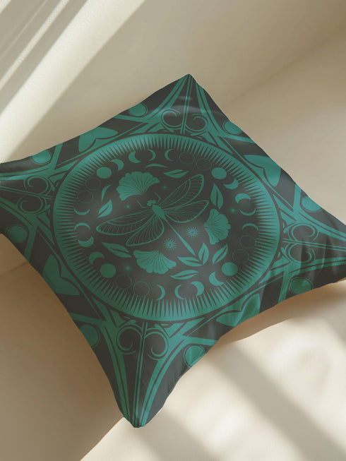 Square pillow cover featuring an intricate emerald green dragonfly design centered in a medallion surrounded by moon phases and Art Nouveau geometric patterns on a dark charcoal background.
