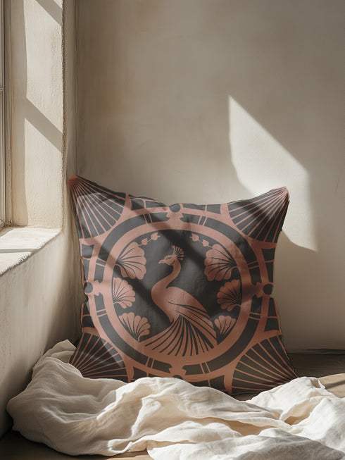 Square pillow cover featuring a stylized copper peacock design centered in a medallion, surrounded by Art Deco fan patterns and shell motifs on a dark forest green background.