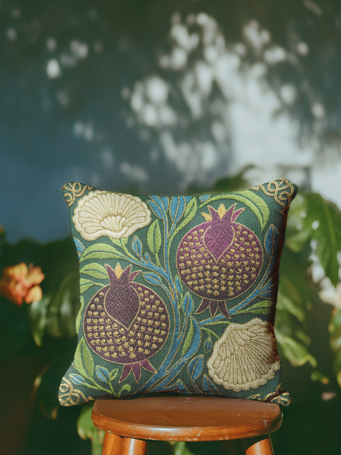 A Grimoire and Goblet decorative pillow cover featuring a Pomegranate and Flower design on a dark midnight teal background. The artwork uses a faux embroidery effect to create the illusion of raised gold and red threadwork on a smooth fabric. The pattern includes red pomegranates, cream carnations, and green leaves in a William Morris style botanical print. Fits Dark Academia, Whimsigoth, and Victorian Gothic decor. Double-sided print with hidden zipper. Cover only.