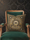 A square charcoal black pillow cover featuring a celestial All-Seeing Eye medallion in a dark academia style. The central 2D flat print mimics antique gold embroidery with a radial sunburst and the words Past, Present, and Future. Four crescent moons and eight-pointed stars accent the corners in a rust-ochre hue. The smooth polyester fabric has a concealed zipper and a seamless finish, showcasing the vintage trompe-l'œil tapestry design printed on both sides of the cushion cover.