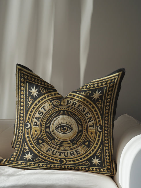 A square charcoal black pillow cover featuring a celestial All-Seeing Eye medallion in a dark academia style. The central 2D flat print mimics antique gold embroidery with a radial sunburst and the words Past, Present, and Future. Four crescent moons and eight-pointed stars accent the corners in a rust-ochre hue. The smooth polyester fabric has a concealed zipper and a seamless finish, showcasing the vintage trompe-l'œil tapestry design printed on both sides of the cushion cover.