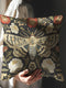 A square decorative throw pillow cover with a dark charcoal background, creating a moody and gothic aesthetic. The design features a large, centrally-placed moth with intricate beige, cream, and blue-grey wings, printed with a high-quality faux embroidered look. Symmetrical botanical elements, including red poppies, white flowers, and green foliage, surround the moth in a style reminiscent of Victorian entomology art.