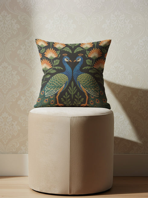 Close up of Grimoire and Goblet peacock pillow cover featuring a high-fidelity faux embroidery print. The design showcases two symmetrical peacocks in midnight charcoal and antique gold, facing each other in a medallion layout surrounded by rust and cream floral vines. The image details the printed illusion of hand-stitched tapestry texture on smooth, soft polyester fabric. Ideal for Dark Academia, Whimsigoth, and Art Nouveau vintage home decor styles. Double-sided print with hidden zipper.