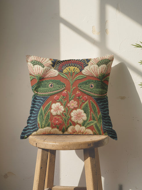 A square throw pillow cover featuring a maximalist botanical serpent illustration in a moody dark academia style. The design depicts a detailed snake with intricate scales winding through a lush arrangement of vintage-style flowers and nocturnal foliage. The color palette is dominated by deep forest greens, muted charcoal, and earthy floral tones, creating a psychedelic yet sophisticated aesthetic. This high-quality polyester cushion cover has a smooth, flat texture and a concealed zipper for a seamless fin