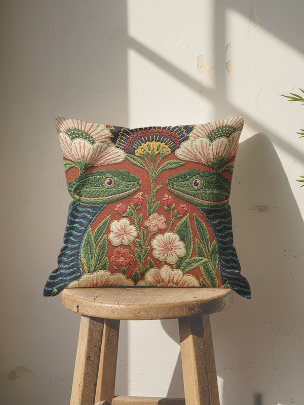A square throw pillow cover featuring a maximalist botanical serpent illustration in a moody dark academia style. The design depicts a detailed snake with intricate scales winding through a lush arrangement of vintage-style flowers and nocturnal foliage. The color palette is dominated by deep forest greens, muted charcoal, and earthy floral tones, creating a psychedelic yet sophisticated aesthetic. This high-quality polyester cushion cover has a smooth, flat texture and a concealed zipper for a seamless fin