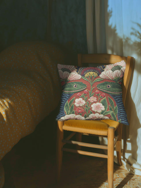 A square throw pillow cover featuring a maximalist botanical serpent illustration in a moody dark academia style. The design depicts a detailed snake with intricate scales winding through a lush arrangement of vintage-style flowers and nocturnal foliage. The color palette is dominated by deep forest greens, muted charcoal, and earthy floral tones, creating a psychedelic yet sophisticated aesthetic. This high-quality polyester cushion cover has a smooth, flat texture and a concealed zipper for a seamless fin