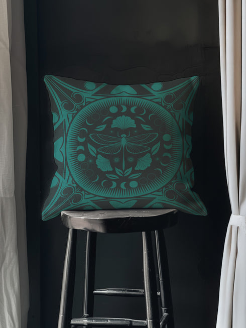 Square pillow cover featuring an intricate emerald green dragonfly design centered in a medallion surrounded by moon phases and Art Nouveau geometric patterns on a dark charcoal background.