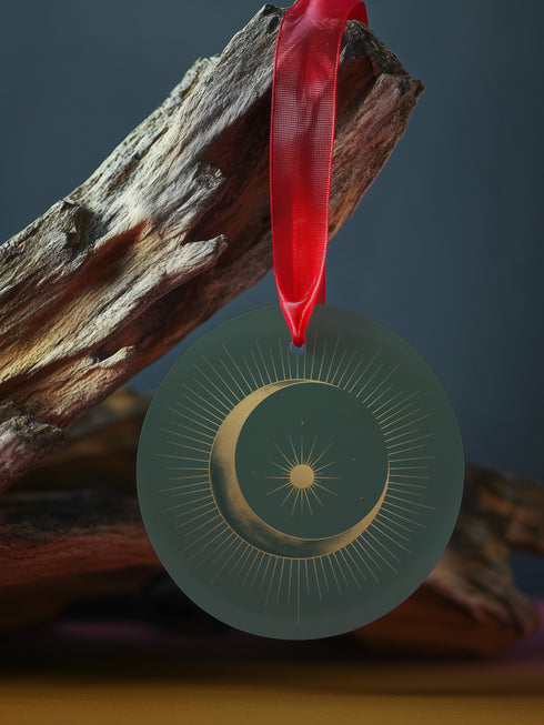 Round metal ornament featuring golden crescent moon and star design with Art Deco sunburst pattern on black background. 3.5-inch diameter piece with celestial motifs and crimson ribbon. Double-sided astronomical artwork.