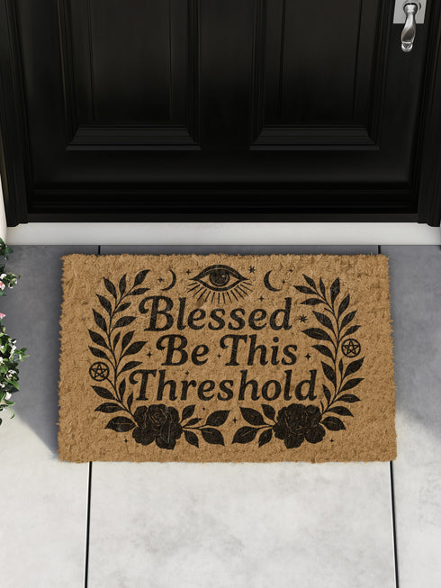Eco-friendly coir doormat with mystical black print reading “Blessed Be This Threshold,” featuring occult symbols like crescent moons, pentacles, all-seeing eye, and roses, styled on various front steps and entryways including outdoor stoops and interiors with pets, ideal for witchy home décor and spiritual gifting.
