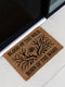 Rectangular coir doormat measuring 24x16 inches featuring black printed text reading “Blood of the Wild, Born of the Ward” with an all-seeing eye symbol and antler-branch illustration. Made from natural coconut fiber with a durable black vinyl backing, this outdoor doormat is weather-resistant and ideal for gothic, witchy, or folklore-inspired entryways.