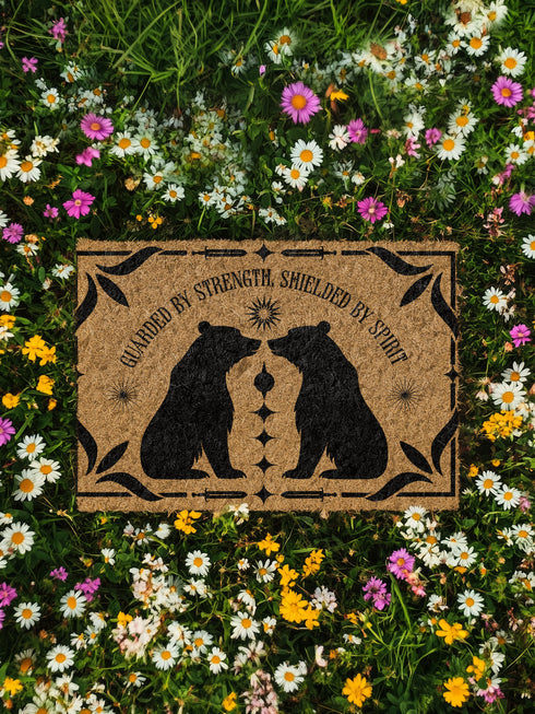 Natural coir doormat featuring two black bear silhouettes facing each other, surrounded by botanical and celestial accents. The mat is made from eco-friendly coir fiber with a slip-resistant vinyl backing, ideal for outdoor use in covered entryways.