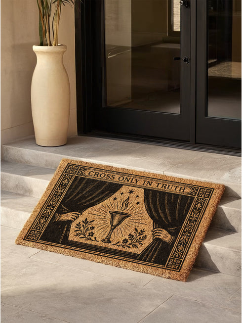 A rectangular doormat made from natural, textured brown coir fiber, featuring a striking black gothic design for spiritual threshold protection. The centerpiece of this witchy welcome mat is a sacred flaming chalice, set between two parted curtains for a dramatic entryway statement. Above the occult imagery, the phrase 'Cross Only In Truth' is printed in a mystical font reminiscent of ancient spellbooks, making this metaphysical and dark academia decor a powerful symbol for a protected home. This is a doorm