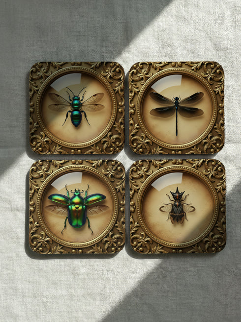 Set of four luxury coasters featuring taxidermy inspired specimen entomology art, showcasing detailed illustrations of beetles and dragonflies encapsulated within ornate, gold baroque frames. The square drink coasters are crafted from masonite hardboard with a waterproof high-gloss finish, protecting delicate surfaces during dining rituals. Essential gothic barware, complementing any fine cocktail, esoteric tea, or wine served in a Goblet. A premium curio cabinet accent by Grimoire and Goblet.