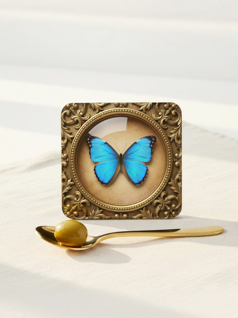 Set of four Gothic Entomology Coasters featuring square, ornate gold frames surrounding taxidermy-inspired butterfly and moth specimen prints in high-gloss finish. Ideal barware from Grimoire and Goblet for Dark Academia and witchy home decor.