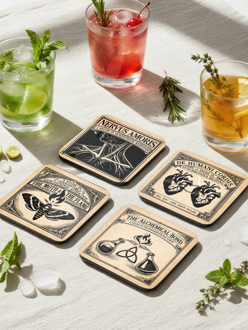 Set of four 4-inch square anatomical love coasters by Grimoire and Goblet. Each coaster features a black ink illustration on an antique tan parchment background in a Victorian scientific style. Designs include linked anatomical hearts for "De Humani Cordis," a triquetra and alchemy flasks for "The Alchemical Bond," a Death's Head moth for "The Moth & The Flame," and a study of neck nerves for "Nervus Amoris." Ideal for a Victorian grimoire aesthetic and gothic romance home bar decor.