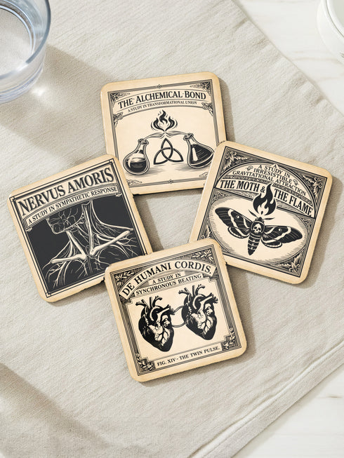 Set of four 4-inch square anatomical love coasters by Grimoire and Goblet. Each coaster features a black ink illustration on an antique tan parchment background in a Victorian scientific style. Designs include linked anatomical hearts for "De Humani Cordis," a triquetra and alchemy flasks for "The Alchemical Bond," a Death's Head moth for "The Moth & The Flame," and a study of neck nerves for "Nervus Amoris." Ideal for a Victorian grimoire aesthetic and gothic romance home bar decor.
