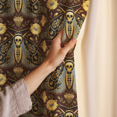 Grimoire and Goblet blackout curtains featuring a repeating Death's Head Moth pattern. The design utilizes a trompe-l'œil effect to mimic raised gold embroidery on a deep espresso brown background. The moths feature skull thoraxes and slate blue wings, surrounded by antique gold peonies and vines in a symmetrical damask layout. The fabric is a smooth, satiny heavyweight polyester with a white reverse side, offering light-blocking functionality.