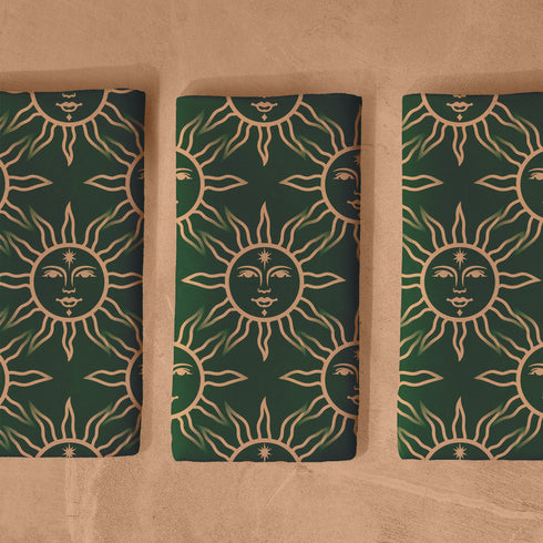 Elegant forest green cloth napkins featuring a golden sun motif, crafted from durable polyester in a set of four, perfect for refined dining.