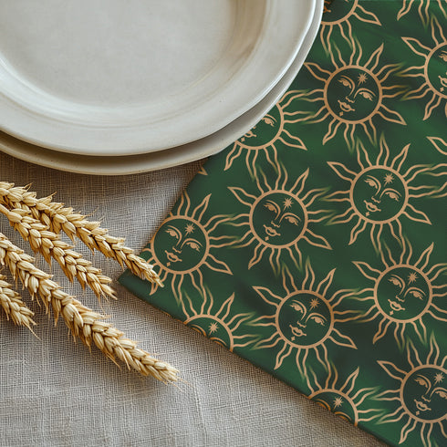 Elegant forest green cloth napkins featuring a golden sun motif, crafted from durable polyester in a set of four, perfect for refined dining.