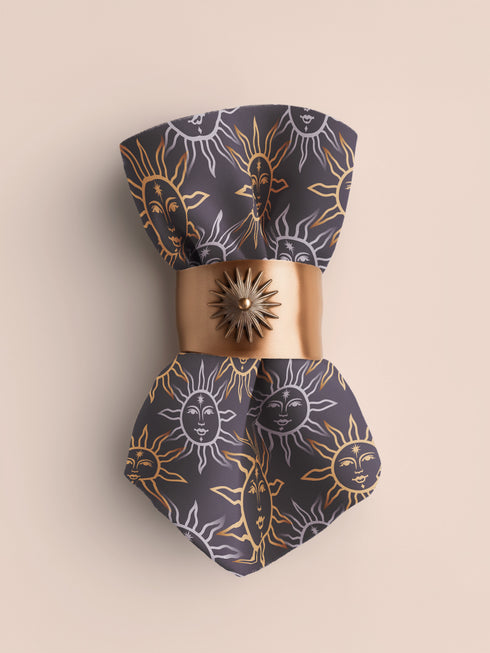 Four-piece cloth napkin set with celestial sun motifs in gold and silver on a deep navy background, made of durable, lint-resistant polyester.