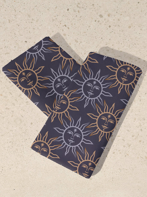 Four-piece cloth napkin set with celestial sun motifs in gold and silver on a deep navy background, made of durable, lint-resistant polyester.