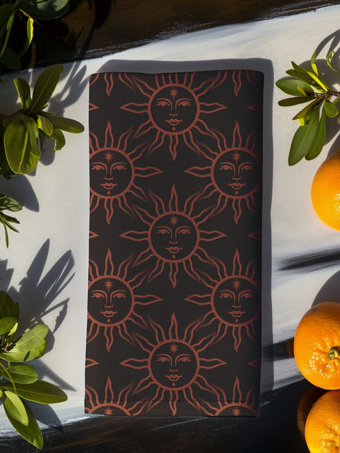 Elegant black cloth napkins with a deep red celestial sun motif, crafted from polyester in a four-piece set, designed for sophisticated dining.