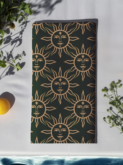 Set of four forest green cloth napkins featuring a gold sun motif, made from polyester, measuring 18'' × 18''.