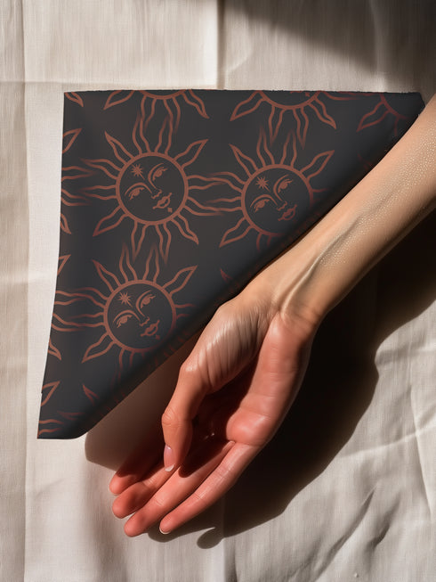 Elegant black cloth napkins with a deep red celestial sun motif, crafted from polyester in a four-piece set, designed for sophisticated dining.
