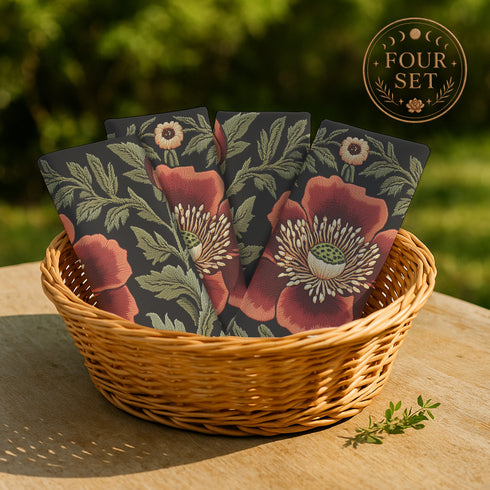 A four-piece cloth napkin set featuring oversized embroidered-style red poppy flowers with green foliage on a deep black background; square-shaped, made of soft polyester with one-sided print and white reverse.