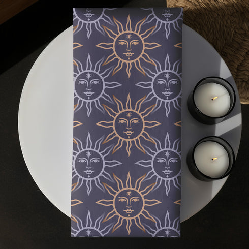 Four-piece cloth napkin set with celestial sun motifs in gold and silver on a deep navy background, made of durable, lint-resistant polyester.