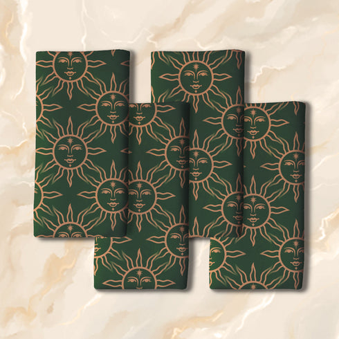 Elegant forest green cloth napkins featuring a golden sun motif, crafted from durable polyester in a set of four, perfect for refined dining.