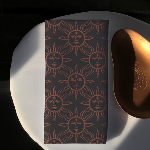 Elegant black cloth napkins with a deep red celestial sun motif, crafted from polyester in a four-piece set, designed for sophisticated dining.