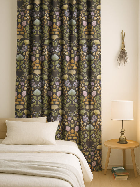 Luxury blackout curtain panel featuring a dark background with a symmetrical botanical pattern of embroidered-style wildflowers in muted pastel and golden tones. The curtain has a rich satiny texture and a 4-inch rod pocket top. Printed on one side, white backing.