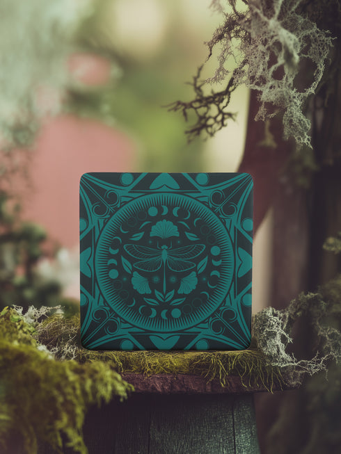 Square ceramic coaster featuring a detailed emerald green dragonfly illustration centered in a medallion, surrounded by moon phases and Art Nouveau patterns on a dark background.