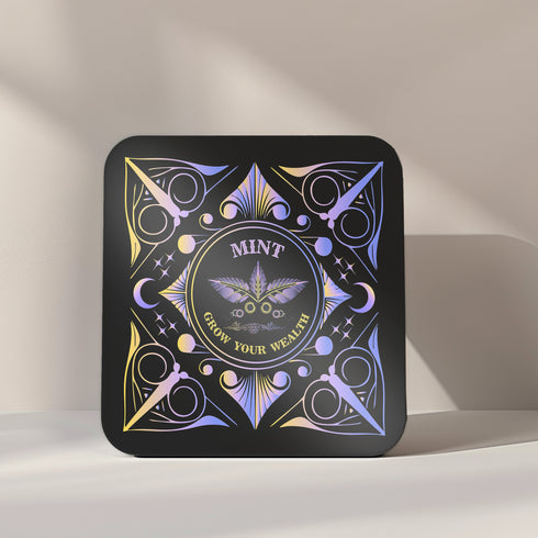 A 4-piece wealth-themed coaster set featuring intricate, gold and black designs with iridescent accents. Each coaster is dedicated to a different herb or spice, including basil, bay leaf, cinnamon, and mint, each symbolizing prosperity, abundance, riches, and wealth. The designs feature celestial motifs and geometric patterns, adding a mystical and luxurious touch to the coasters.
