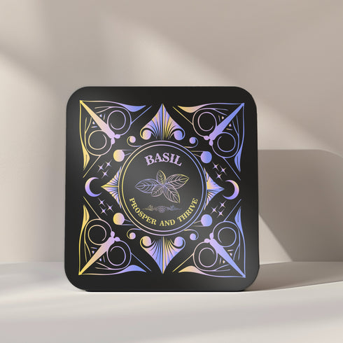 A 4-piece wealth-themed coaster set featuring intricate, gold and black designs with iridescent accents. Each coaster is dedicated to a different herb or spice, including basil, bay leaf, cinnamon, and mint, each symbolizing prosperity, abundance, riches, and wealth. The designs feature celestial motifs and geometric patterns, adding a mystical and luxurious touch to the coasters.