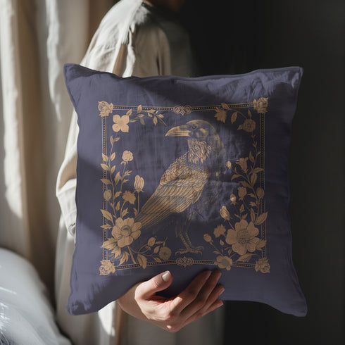 Navy blue throw pillow cover featuring a bronze raven illustration surrounded by intricate floral designs, suitable for gothic or dark academia decor.