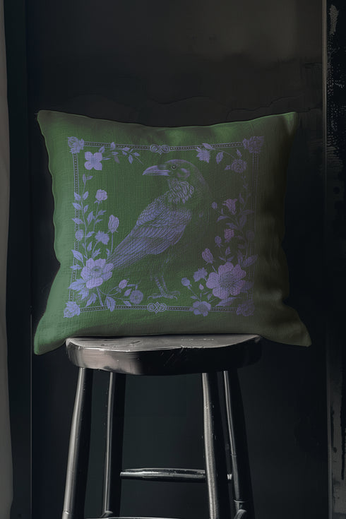 Emerald green throw pillow cover featuring a violet raven illustration surrounded by intricate floral designs, perfect for gothic or dark academia decor.