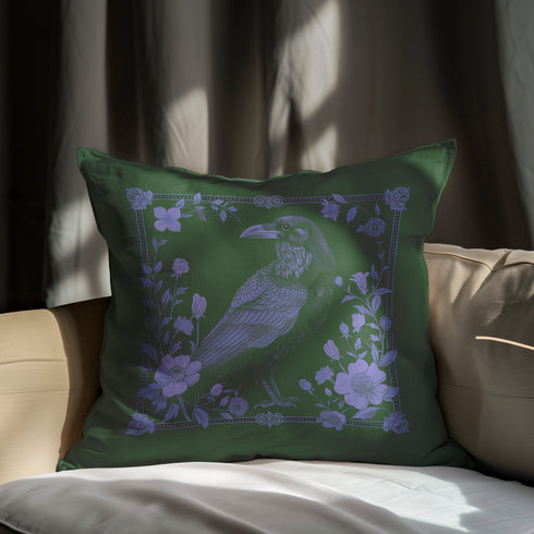Emerald green throw pillow cover featuring a violet raven illustration surrounded by intricate floral designs, perfect for gothic or dark academia decor.