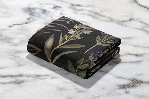 Forest green cotton throw blanket with woven silver moon phases and golden sun motifs, finished with multicolored fringe trim.